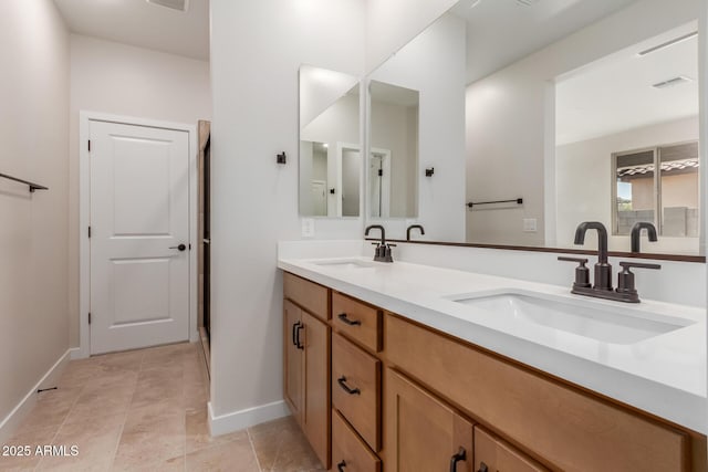 5678 N 205th Ln, Buckeye, AZ 85396 - full bathroom featuring double vanity and baseboards