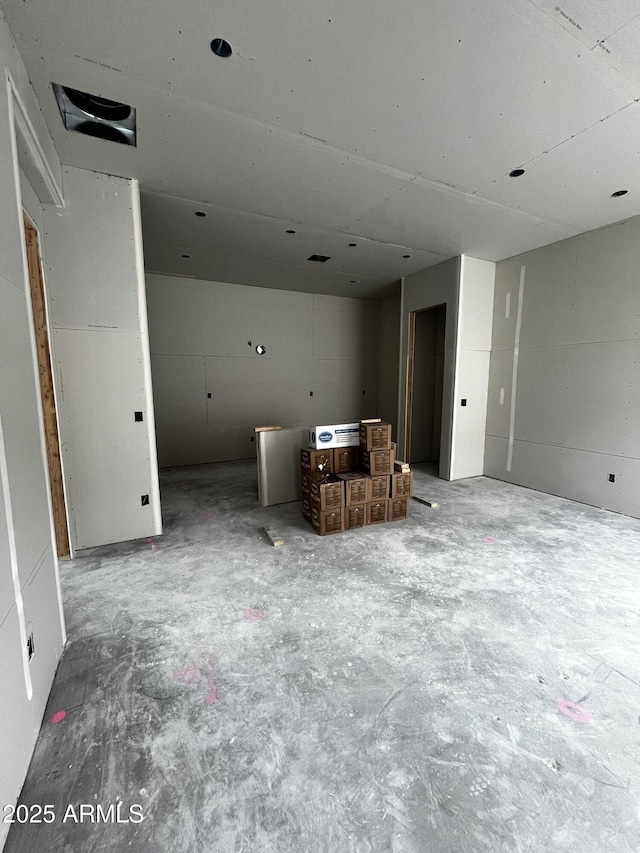 unfurnished living room with concrete floors