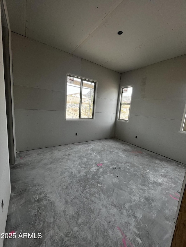 empty room featuring unfinished concrete floors