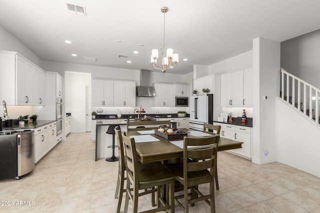 tiled dining room featuring sink and an inviting chandelier