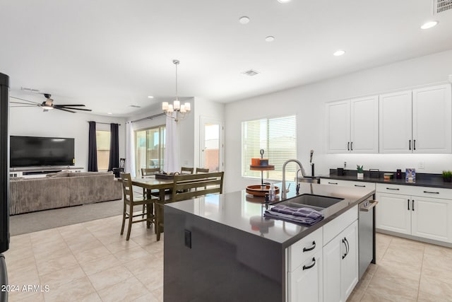 kitchen with an island with sink, white cabinetry, dishwasher, pendant lighting, and sink