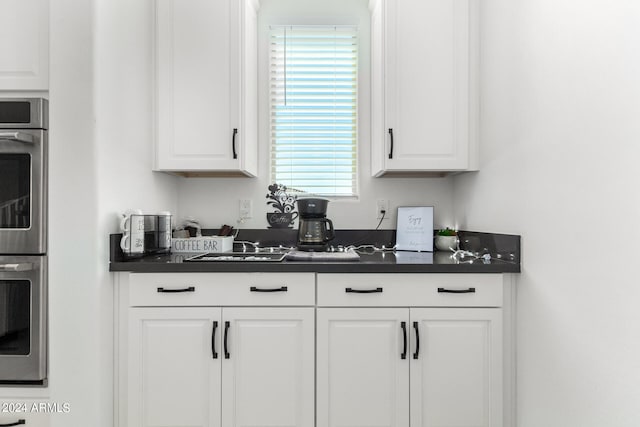 kitchen with double oven and white cabinets