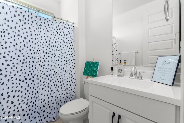 bathroom with vanity, curtained shower, and toilet