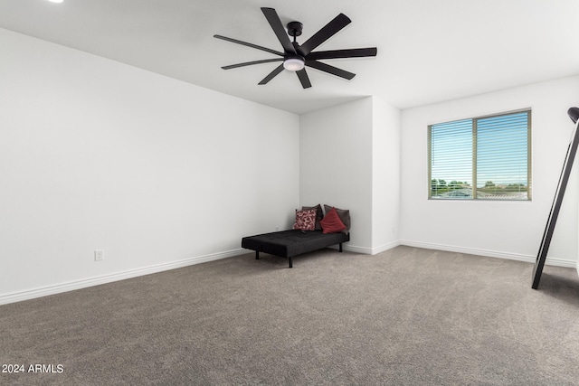 sitting room with ceiling fan and carpet flooring