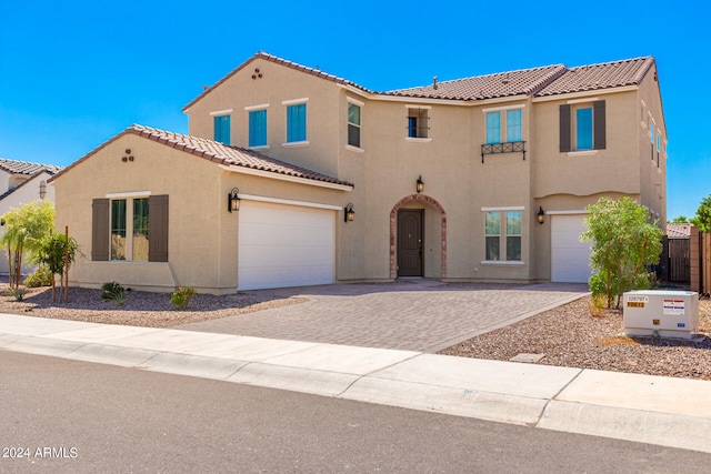 mediterranean / spanish-style home featuring a garage