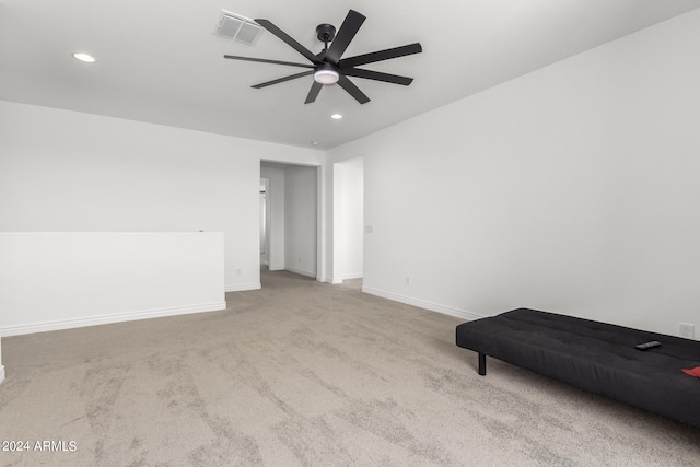 spare room with light carpet and ceiling fan