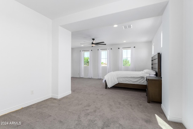 bedroom featuring light colored carpet and ceiling fan