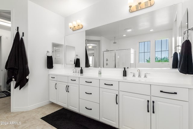 bathroom with vanity, tile patterned floors, and a shower with door