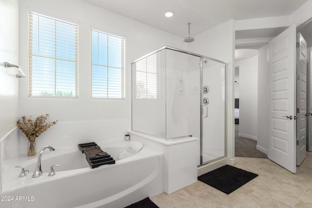 bathroom featuring independent shower and bath and tile patterned flooring