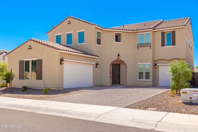 mediterranean / spanish-style home with a garage