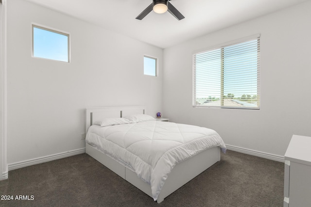 bedroom with ceiling fan and dark colored carpet