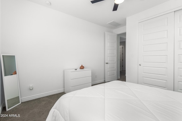 carpeted bedroom featuring a closet and ceiling fan