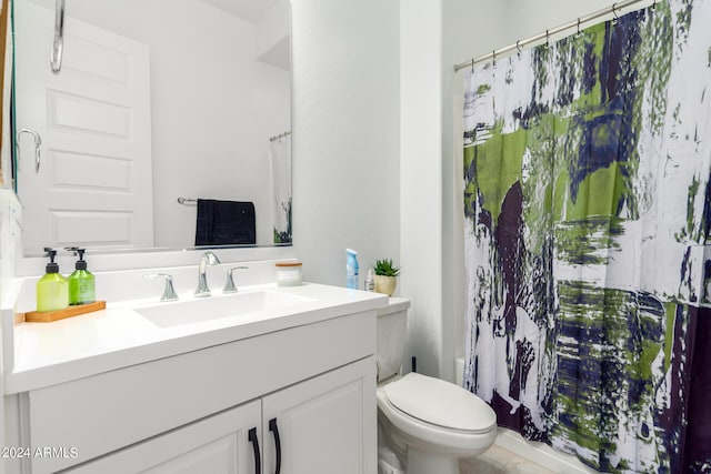 bathroom featuring toilet, a shower with curtain, and vanity