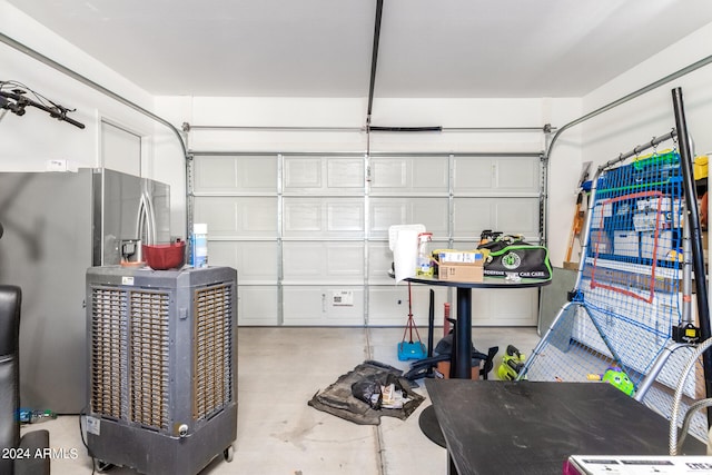 garage with stainless steel fridge