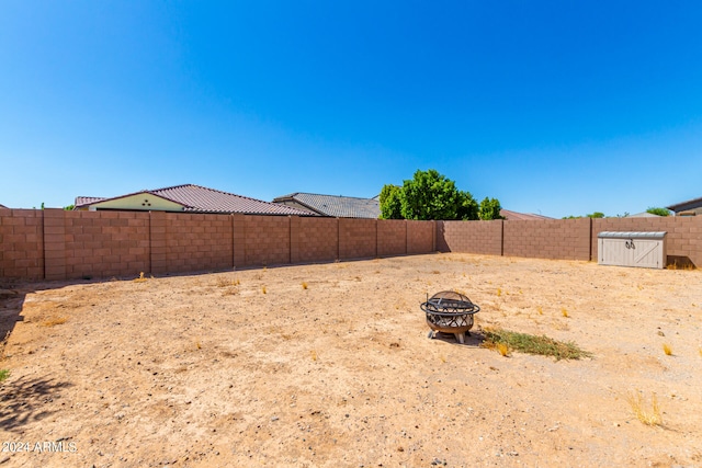 view of yard with a fire pit