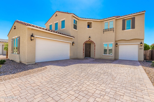 mediterranean / spanish home featuring a garage