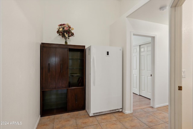 corridor with light tile patterned floors