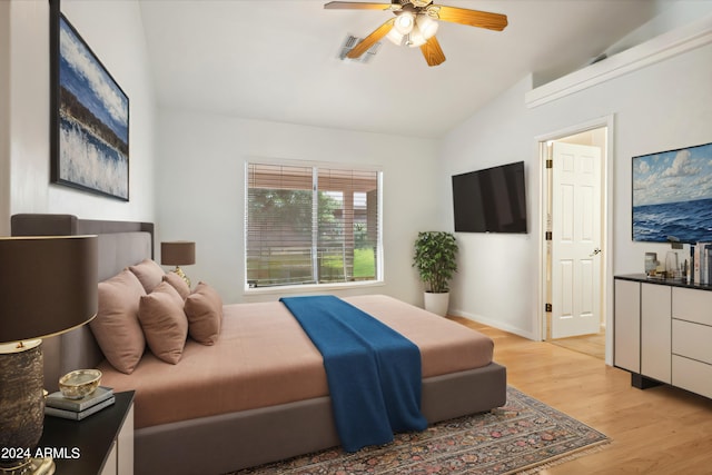 bedroom featuring ceiling fan, lofted ceiling, and light wood-type flooring