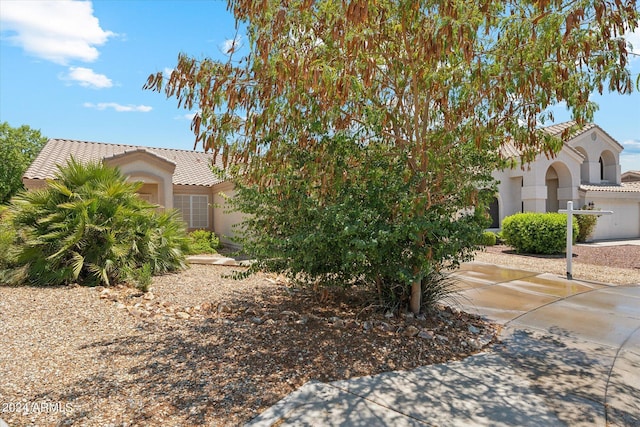 view of front of home featuring a tile roof and stucco siding