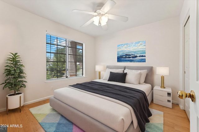 bedroom featuring a closet, ceiling fan, and light hardwood / wood-style flooring