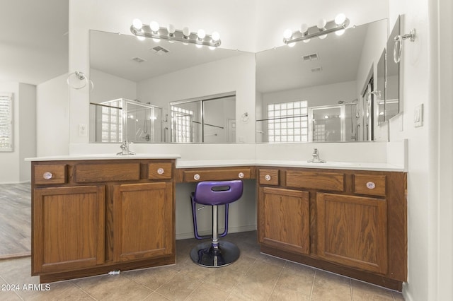 bathroom with vanity and a shower with shower door