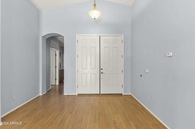 entryway featuring hardwood / wood-style floors and lofted ceiling