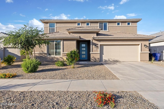 view of front facade with stucco siding, driveway, and an attached garage