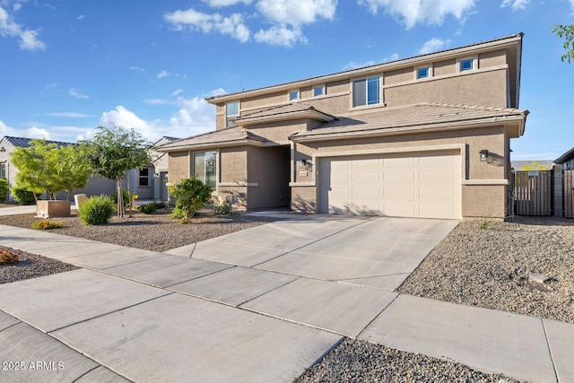 view of front facade featuring stucco siding, a gate, fence, concrete driveway, and an attached garage