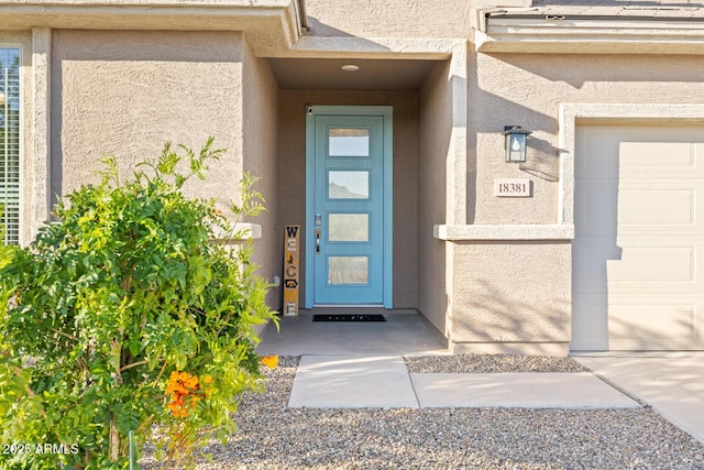 doorway to property featuring stucco siding