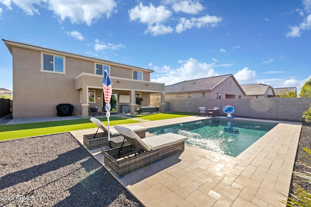 view of swimming pool with a patio, a fenced in pool, and a fenced backyard