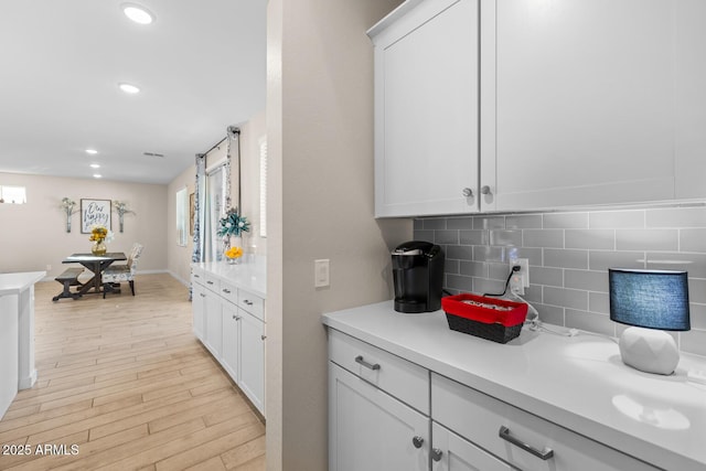 interior space with light countertops, plenty of natural light, and tasteful backsplash