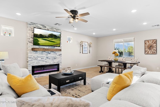 living room with visible vents, a ceiling fan, light wood-style flooring, and recessed lighting