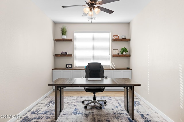 office featuring ceiling fan and baseboards