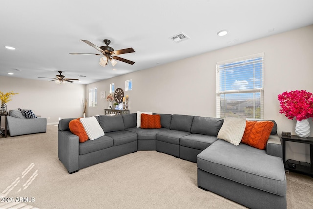 carpeted living room with recessed lighting, visible vents, and ceiling fan