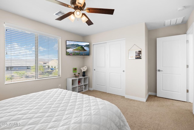 bedroom featuring baseboards, visible vents, a closet, and carpet flooring