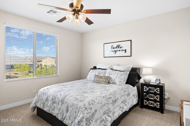bedroom featuring visible vents, light colored carpet, and baseboards