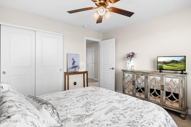 carpeted bedroom featuring ceiling fan, baseboards, visible vents, and a closet