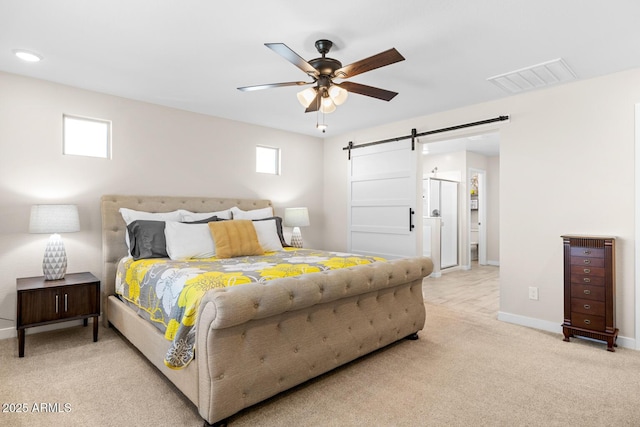 bedroom with visible vents, ceiling fan, a barn door, baseboards, and light carpet