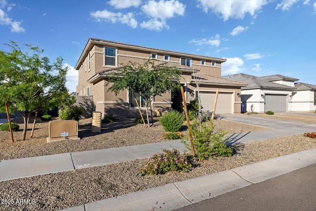 view of front facade with a garage, stucco siding, and driveway