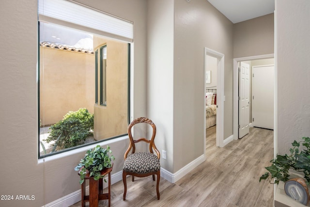 corridor featuring wood finished floors and baseboards