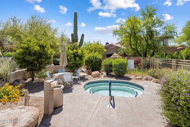 view of pool featuring fence, outdoor dining area, a patio, and a hot tub