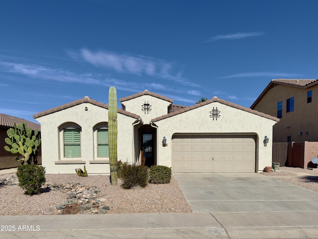 mediterranean / spanish-style house with a garage