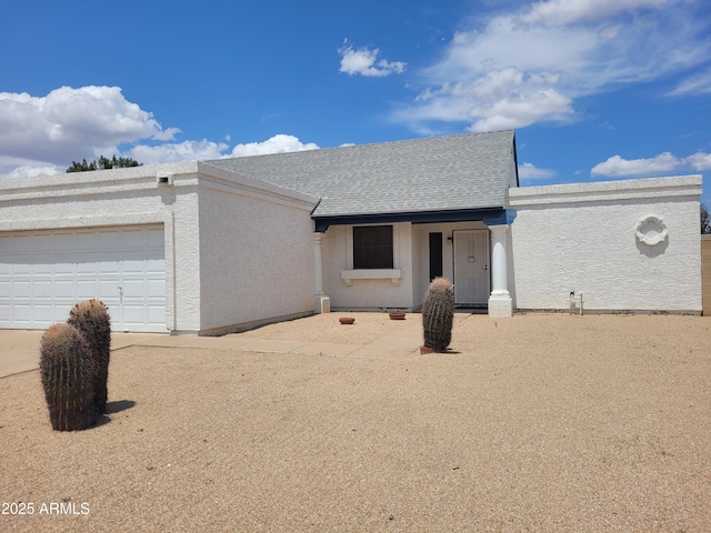 ranch-style home with stucco siding and a garage