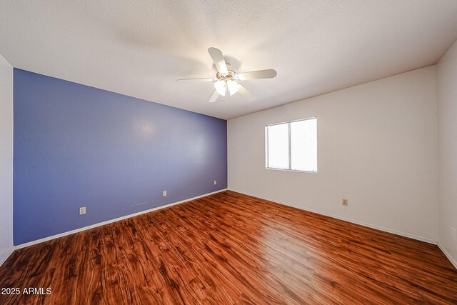 812 E Piute Ave, Phoenix, AZ 85024 - empty room with wood finished floors, a ceiling fan, and baseboards