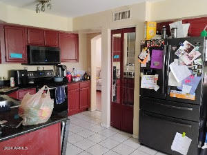 kitchen with black appliances and light tile patterned floors