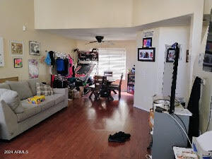 living room with ceiling fan and dark hardwood / wood-style floors