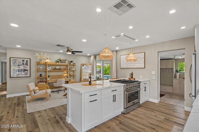 5332 N 81st Pl, Scottsdale, AZ 85250 - kitchen with stainless steel appliances, white cabinetry, light wood-style floors, recessed lighting, and hanging light fixtures