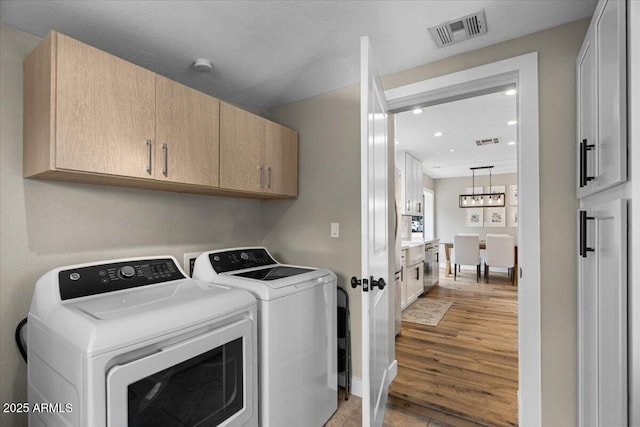 5332 N 81st Pl, Scottsdale, AZ 85250 - laundry area featuring cabinet space, separate washer and dryer, recessed lighting, a chandelier, and light wood-type flooring