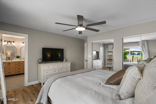 5332 N 81st Pl, Scottsdale, AZ 85250 - bedroom featuring light wood-style floors, two closets, ensuite bath, and a ceiling fan