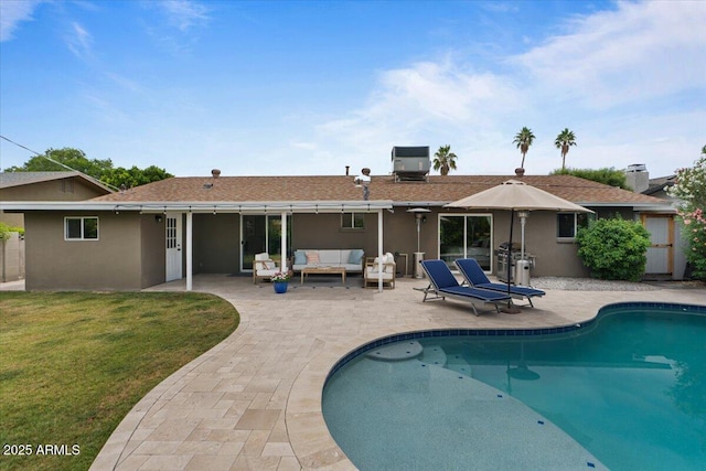 5332 N 81st Pl, Scottsdale, AZ 85250 - rear view of property featuring outdoor lounge area, a patio area, a lawn, an outdoor pool, and stucco siding